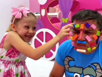 Nastya and dad play with lego toys